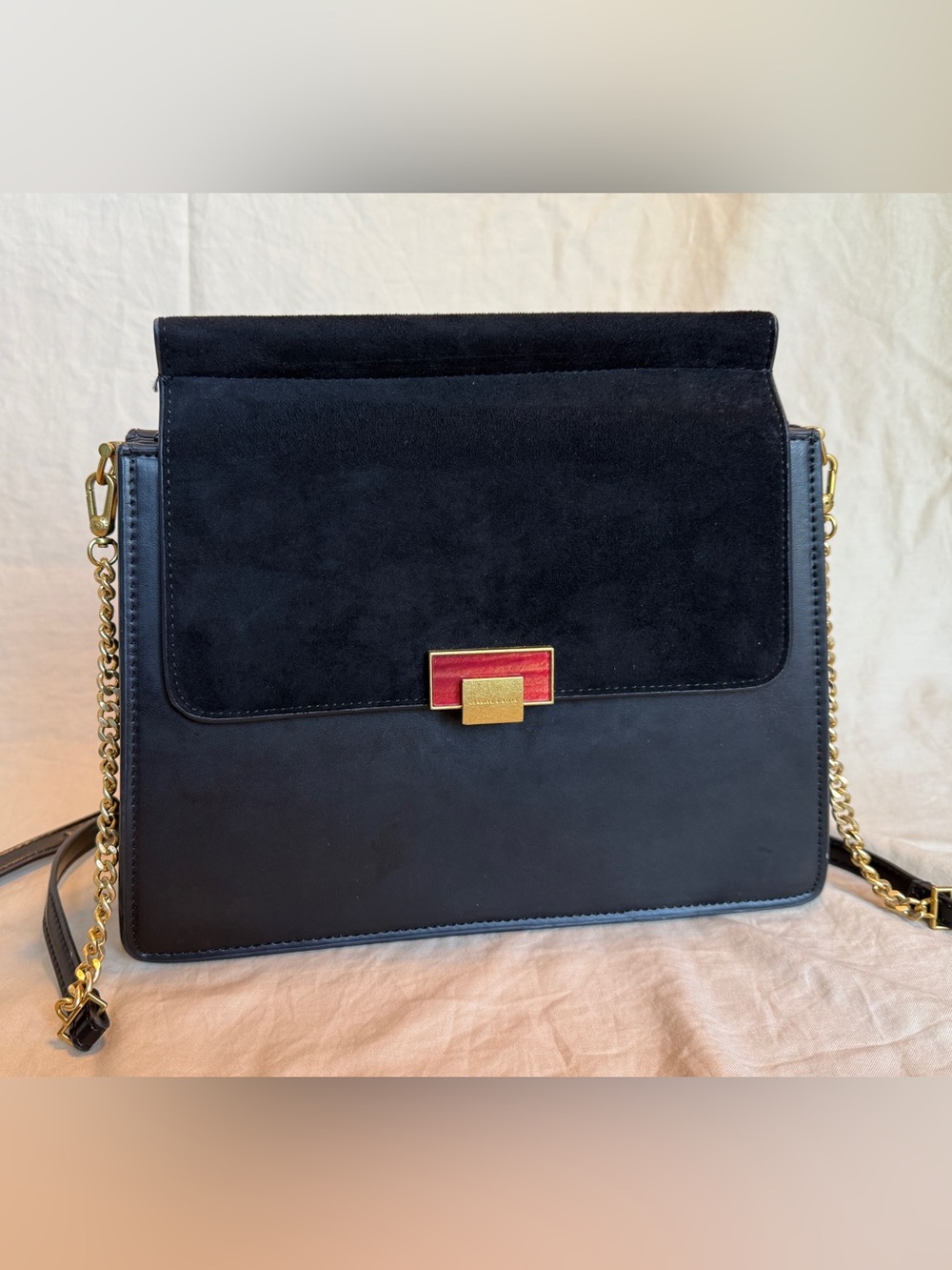 Charles & Keith Black Shoulder Bag with Gold Chain and Red Accent